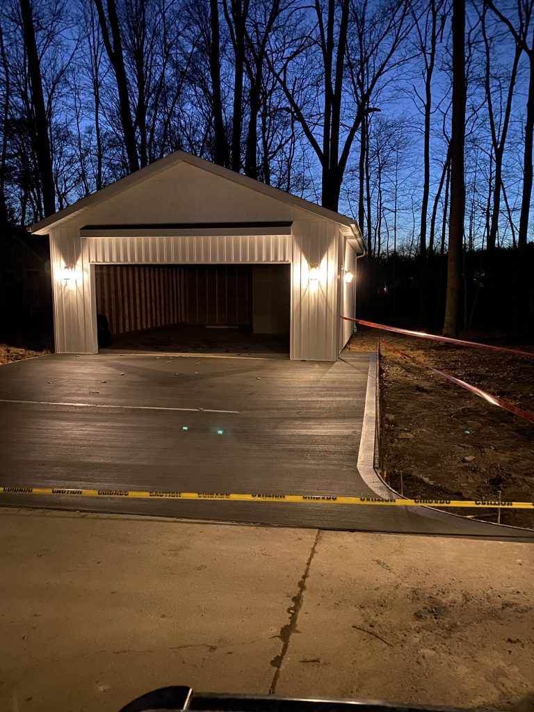Cherokee River delivers trusted home additions, shown by a safe and solid driveway leading to a welcoming garage at dusk.