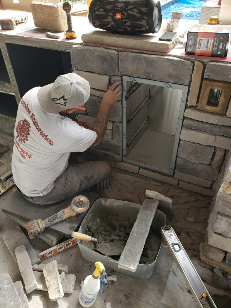 Cherokee River outdoor kitchen shown being upgraded with stone veneer for a stylish and useful backyard living space.